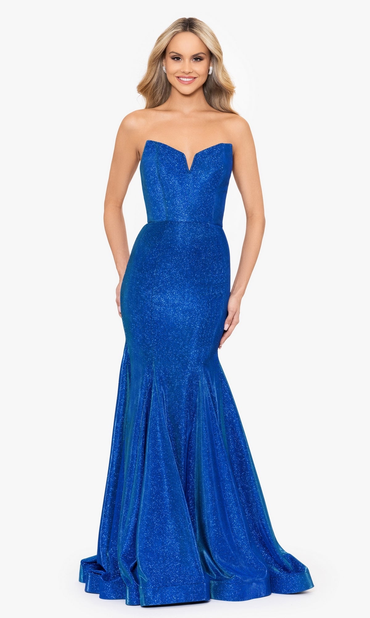A woman smiles against a white background wearing the Strapless Long Blue Mermaid Prom Dress 4720BN, featuring shimmer fabric, a fitted silhouette, flared hem, and strapless design.